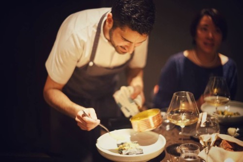 Chef Hudda emerges from the kitchen to add the finishing touches